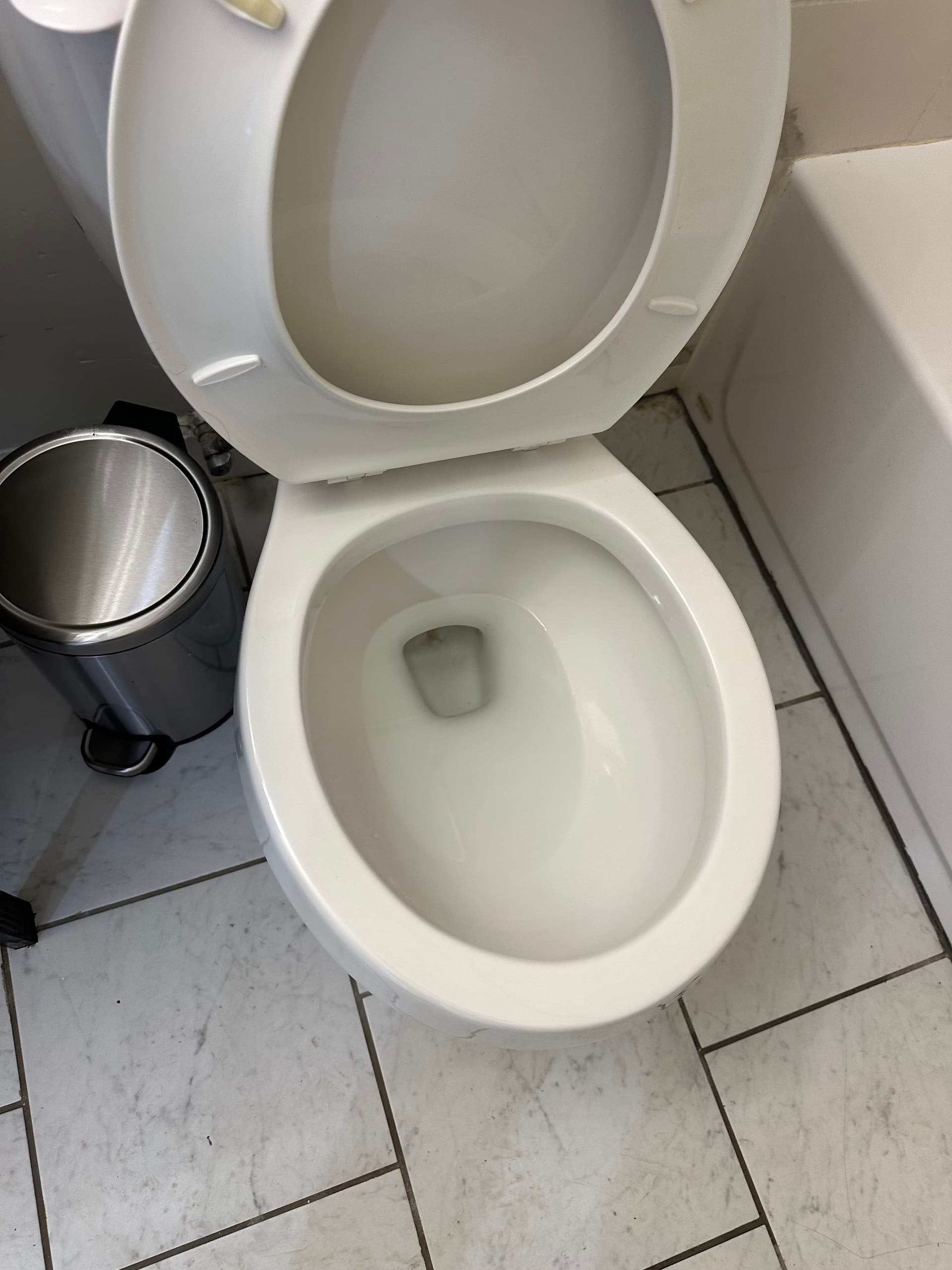 A toilet gleaming white after a bathroom deep clean