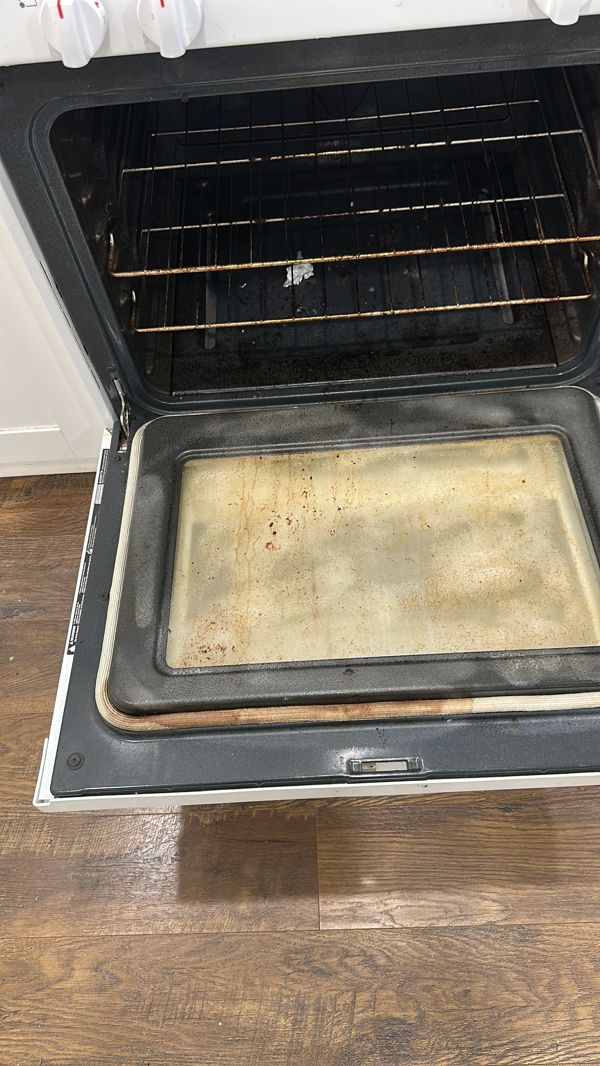 An oven interior with baked-on grease before cleaning
