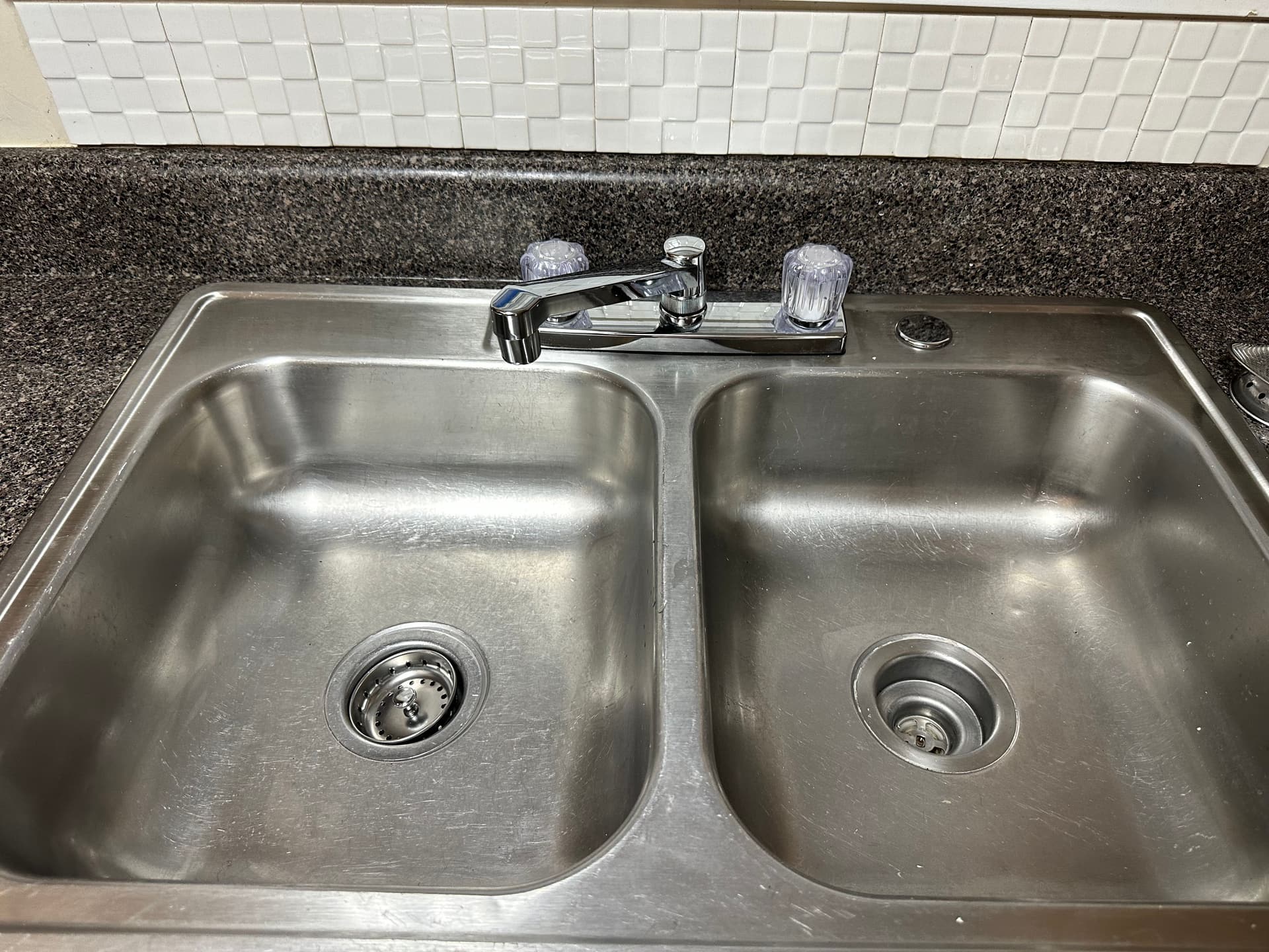 A stainless steel kitchen sink polished after cleaning