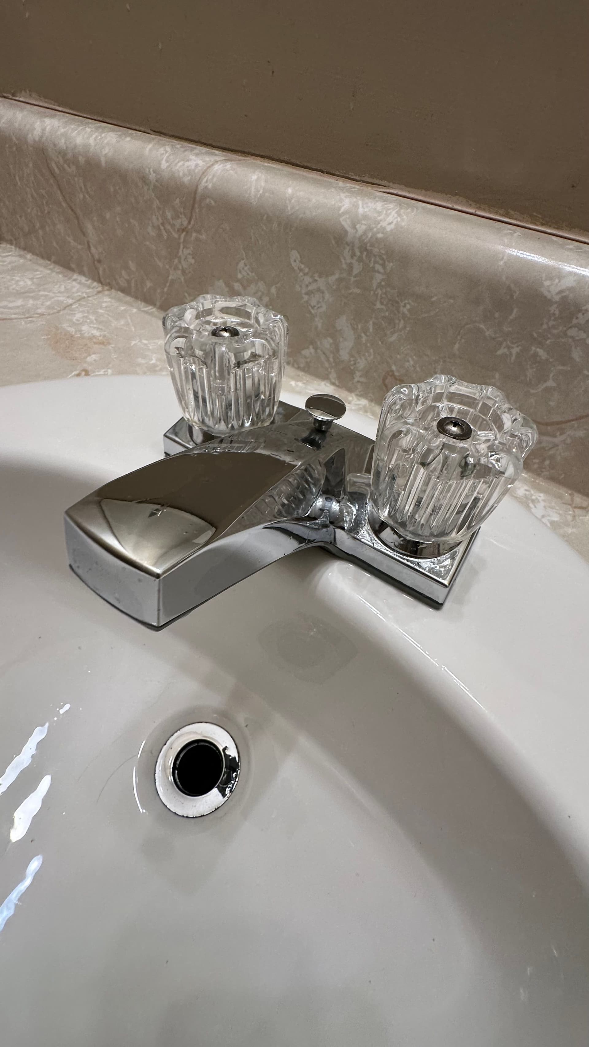A chrome bathroom faucet polished to a shine